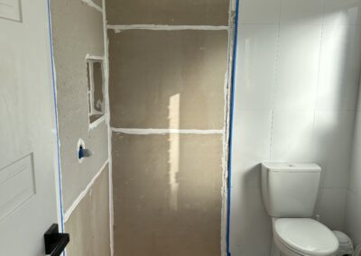 During shower repair in Sydney, new waterproofing and plastering complete.