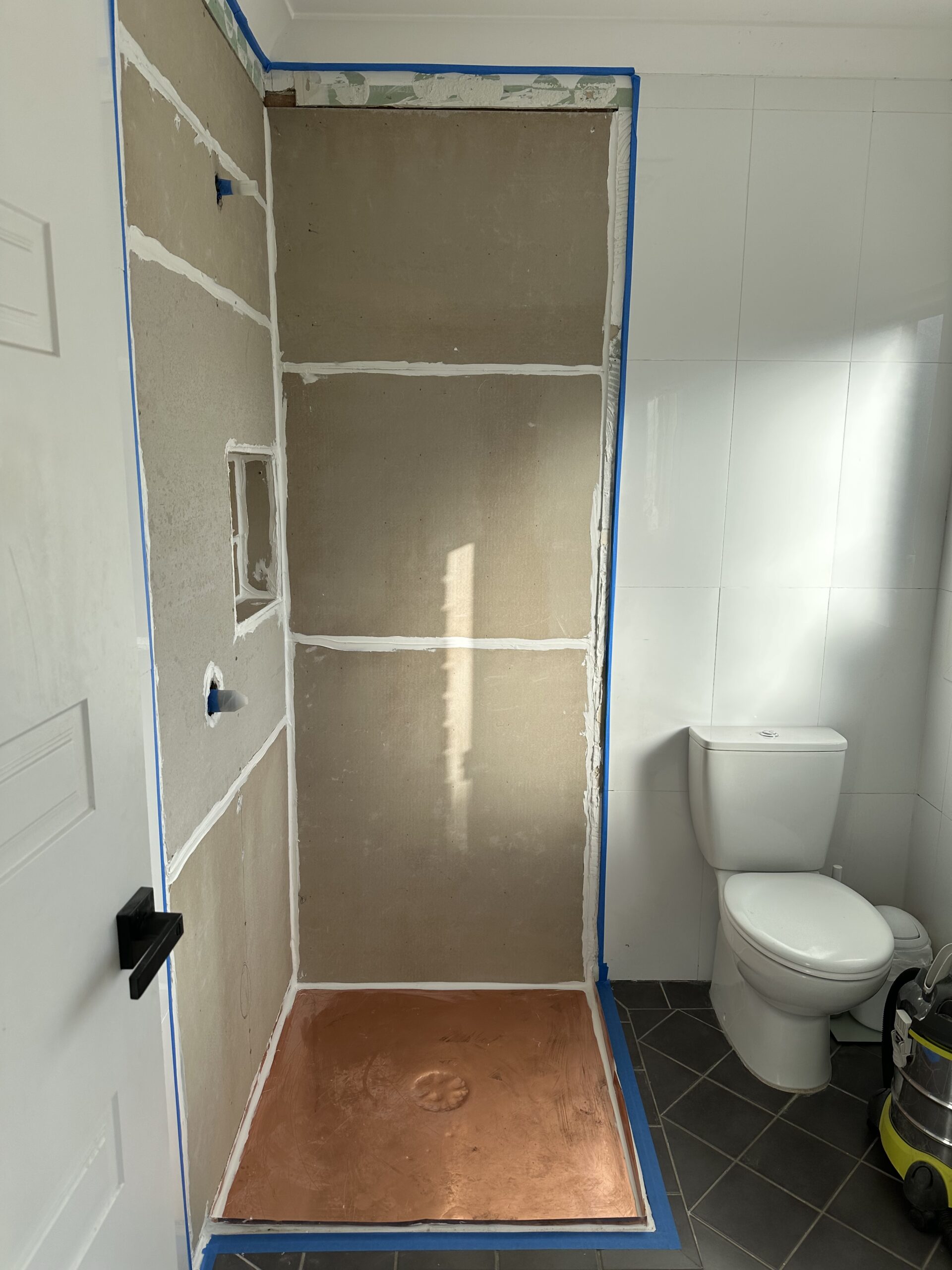 During shower repair in Sydney, new waterproofing and plastering complete.