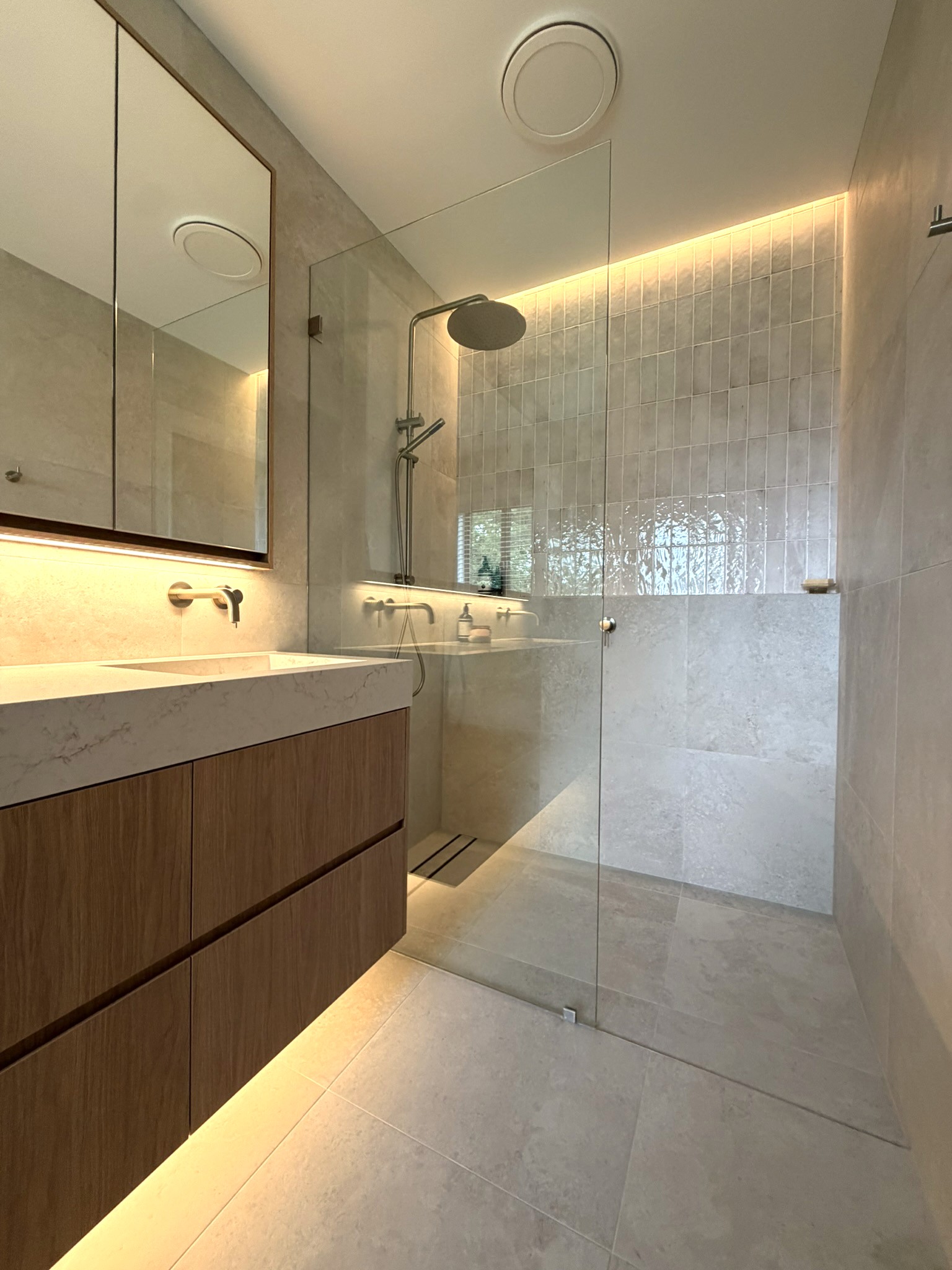 Portrait image of new, blue, modern family kitchen renovation with breakfast bar.